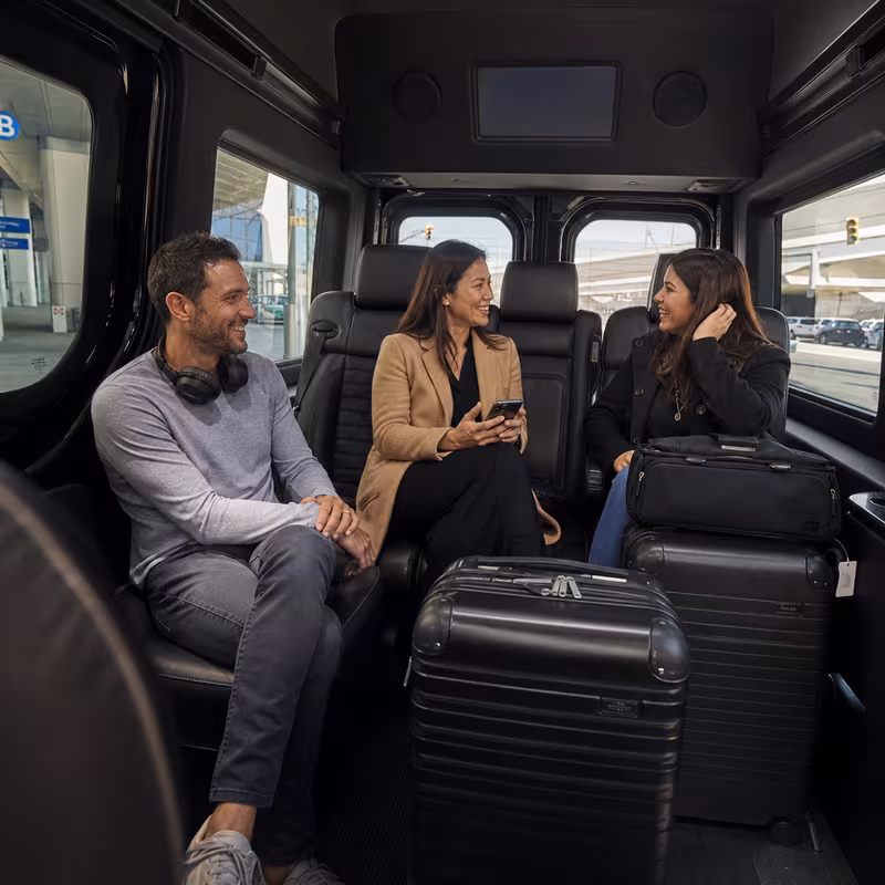 Passengers loading luggage while boarding an Los Angeles group shuttle