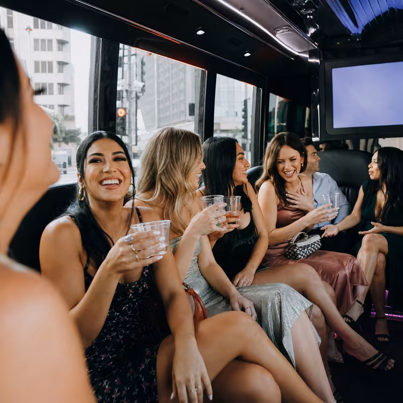 Party bus interior with wraparound leather seating and LED lighting in Los Angeles