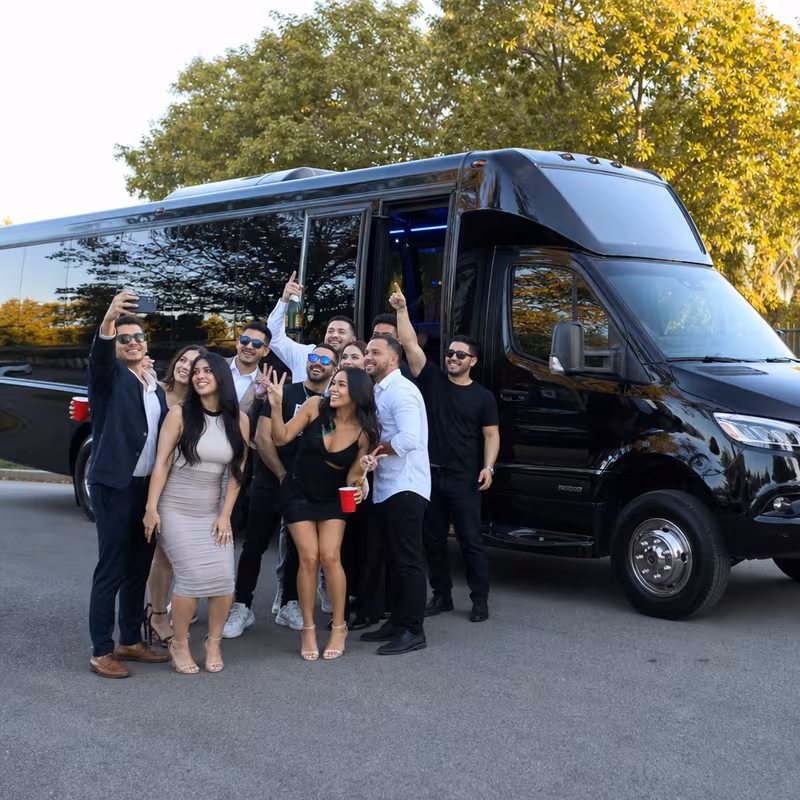 Group boarding a white charter bus for Birthday Transportation transportation in Los Angeles