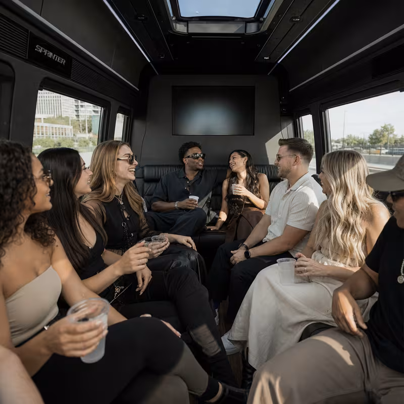 Group boarding a white charter bus for Concert Transportation transportation in Los Angeles