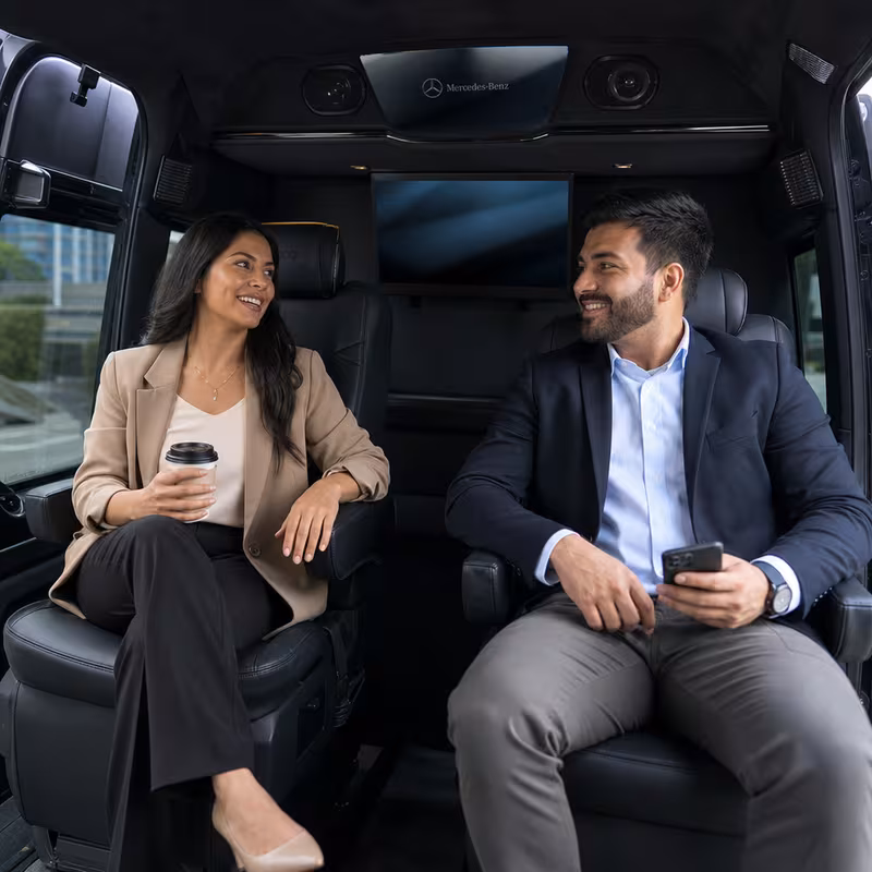 Group boarding a white charter bus for Corporate Transportation transportation in Los Angeles