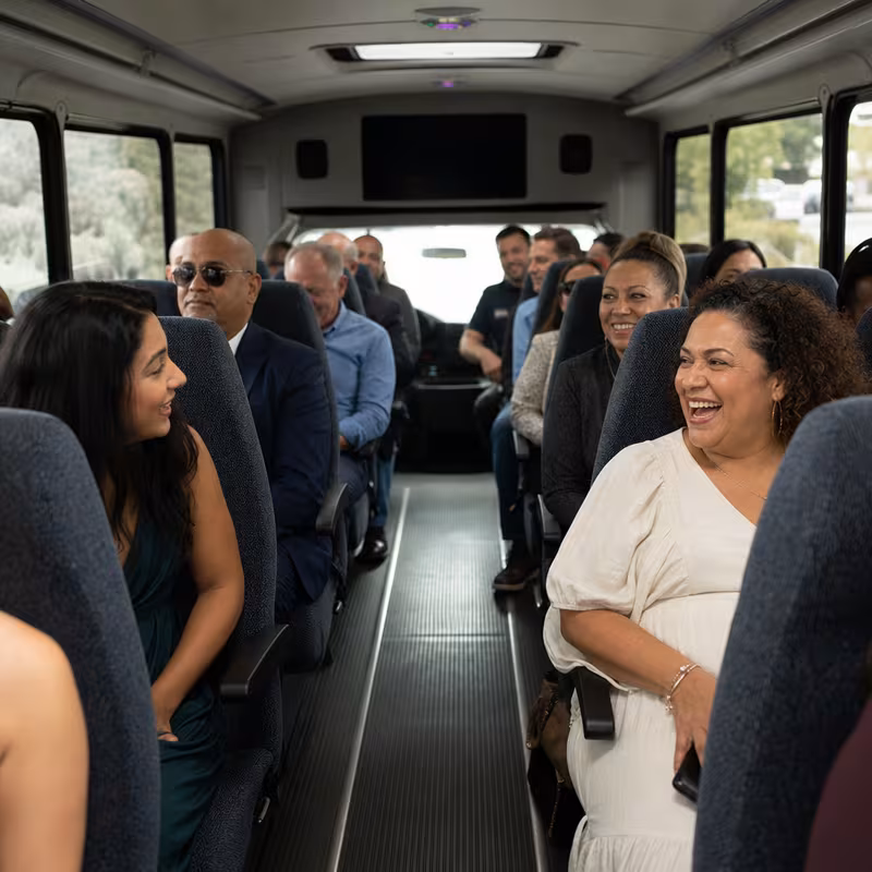 Group boarding a white charter bus for Private Event Transportation transportation in Los Angeles