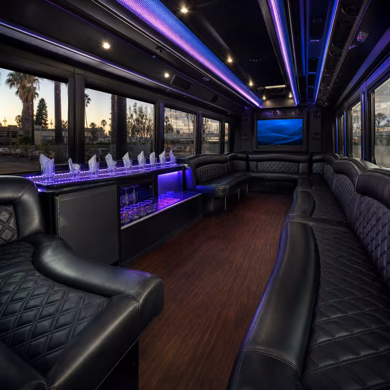 Party bus interior with wraparound leather seating and LED lighting in Los Angeles
