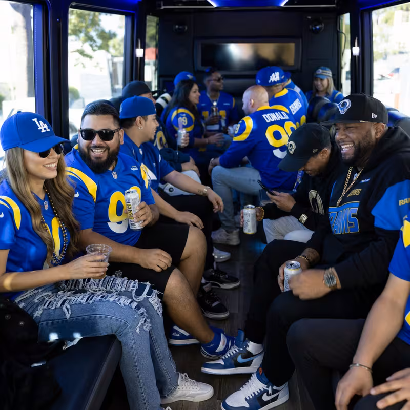 Group boarding a white charter bus for Sporting Event Transportation transportation in Los Angeles