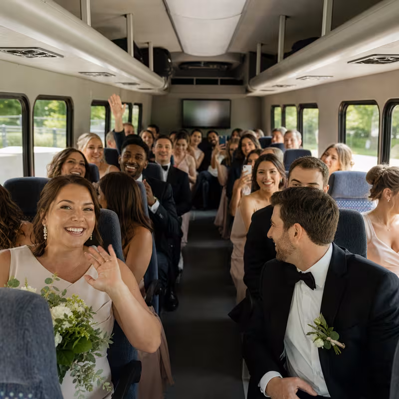 Group boarding a white charter bus for Wedding Transportation transportation in Los Angeles