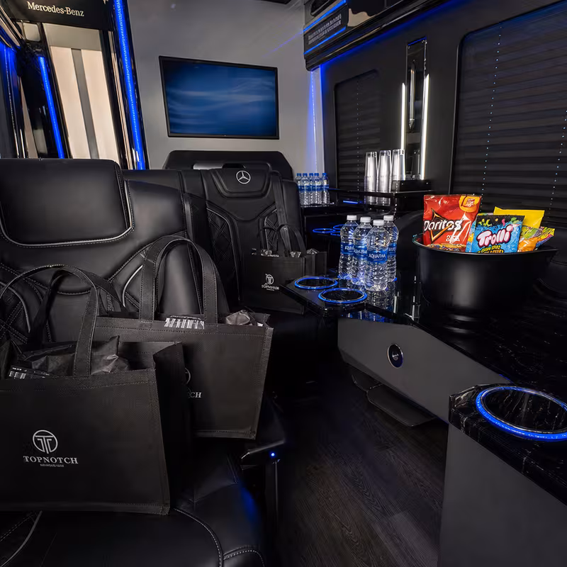 Party bus interior with wraparound leather seating and LED lighting in Los Angeles